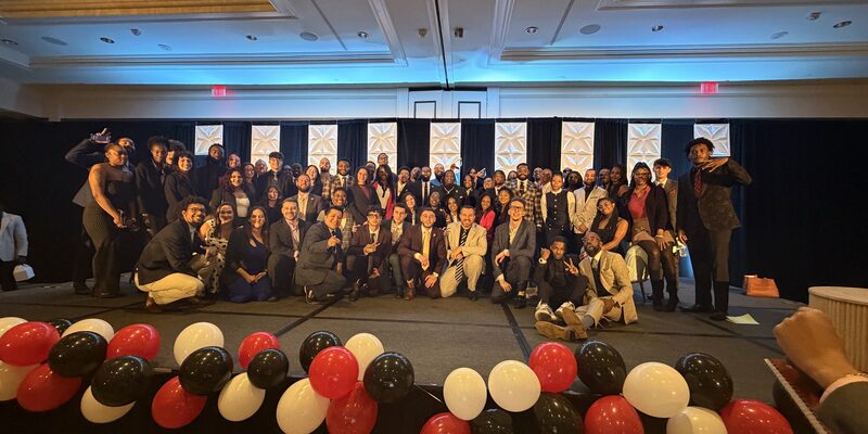 The full Winners Crest Agency team gathered on stage at a company-wide celebration